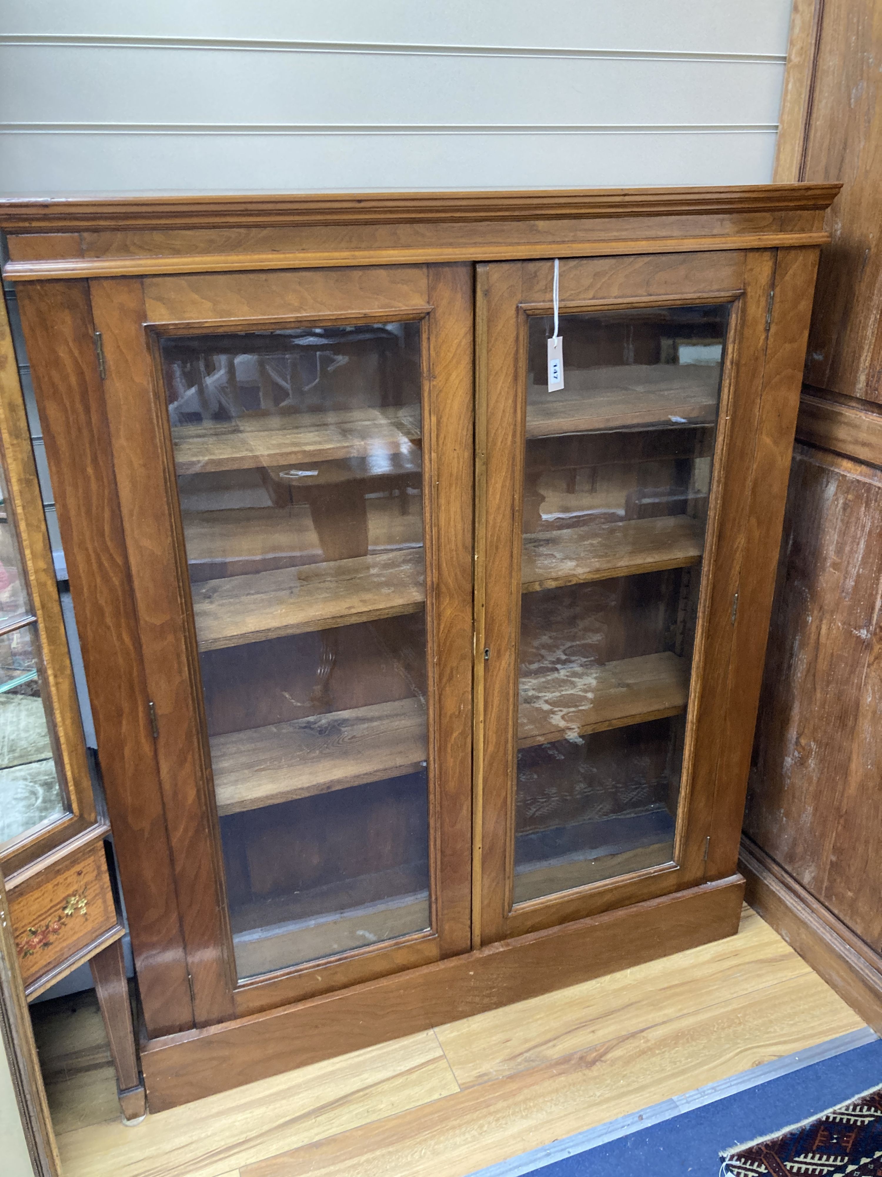 A late Victorian glazed walnut bookcase. W-112, D-28, H-138cm.